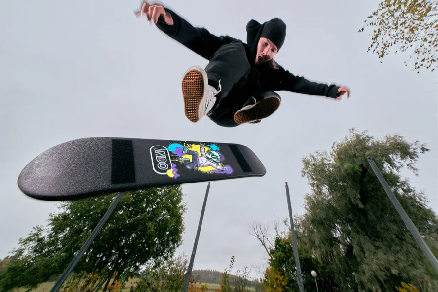 Rider jumping over the INDO Skate on a trampoline